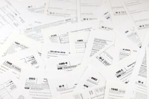Many tax form blanks lies on table. Tax payers paperwork routine and bureaucracy concept